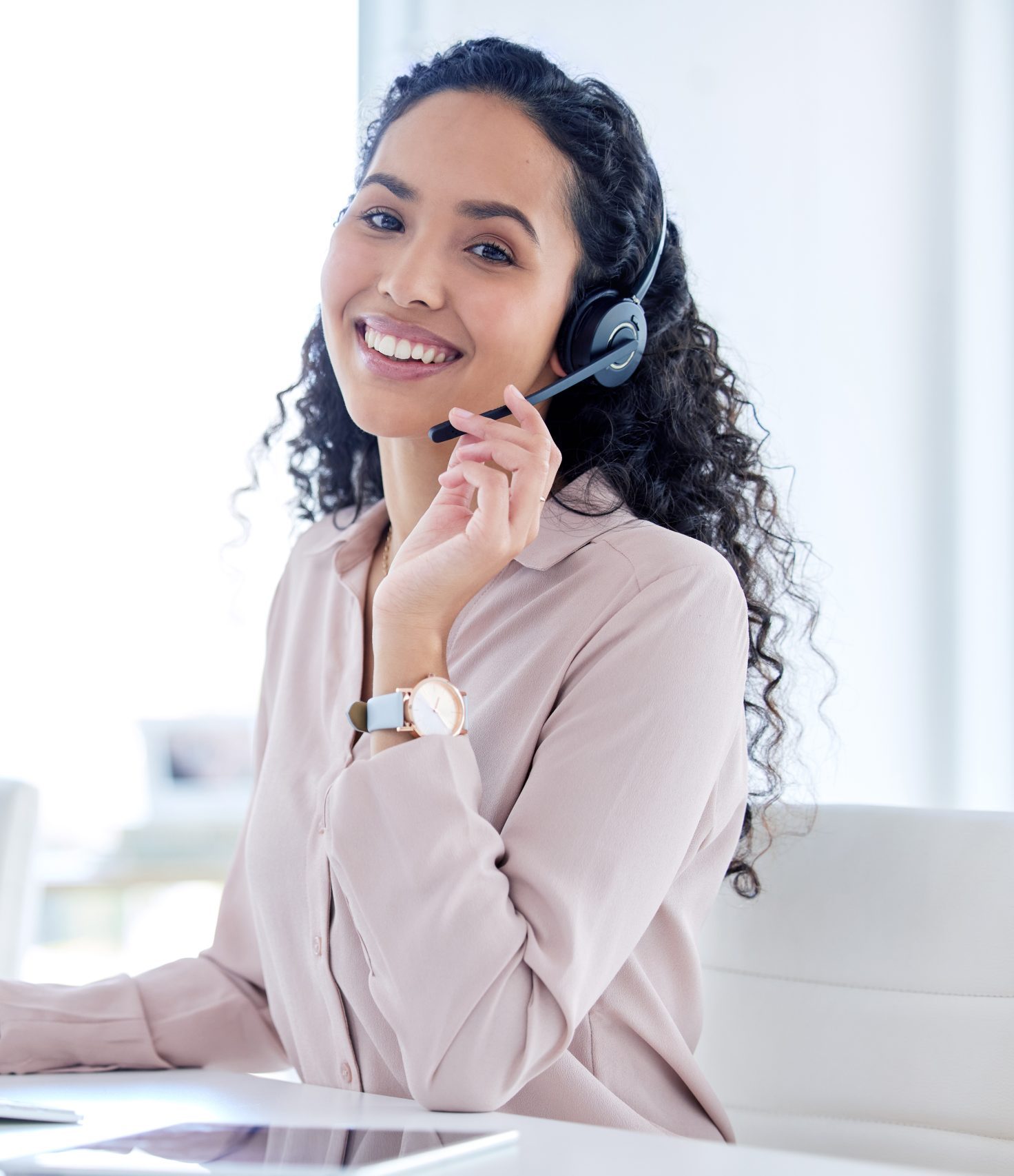 Shot of a young call centre agent sitting with her colleague and using her computer.